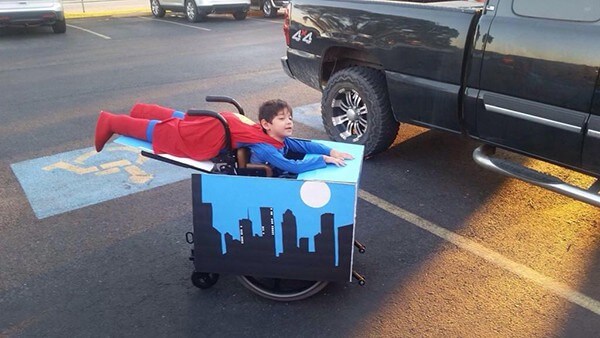 kid in superman design wheelchair