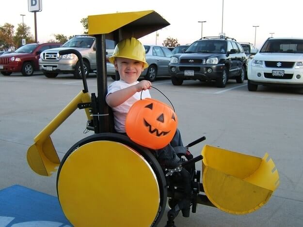 bulldozer wheelchair and kid with pumpkin bucket